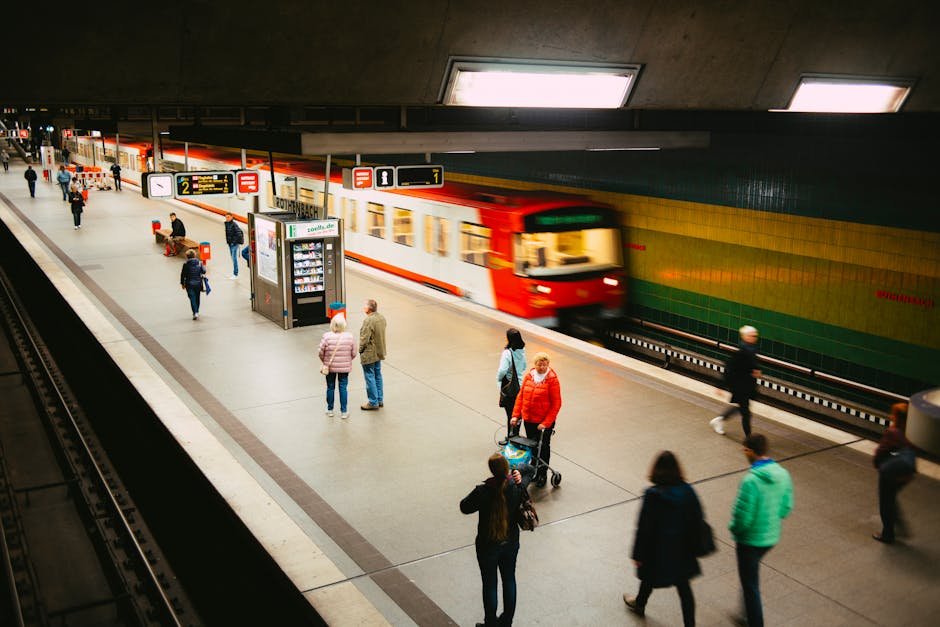 Vibrant subway station scene with people and a fast-moving train on the platform.
